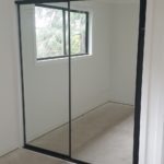 Woodsman wardrobe doors black framed mirror